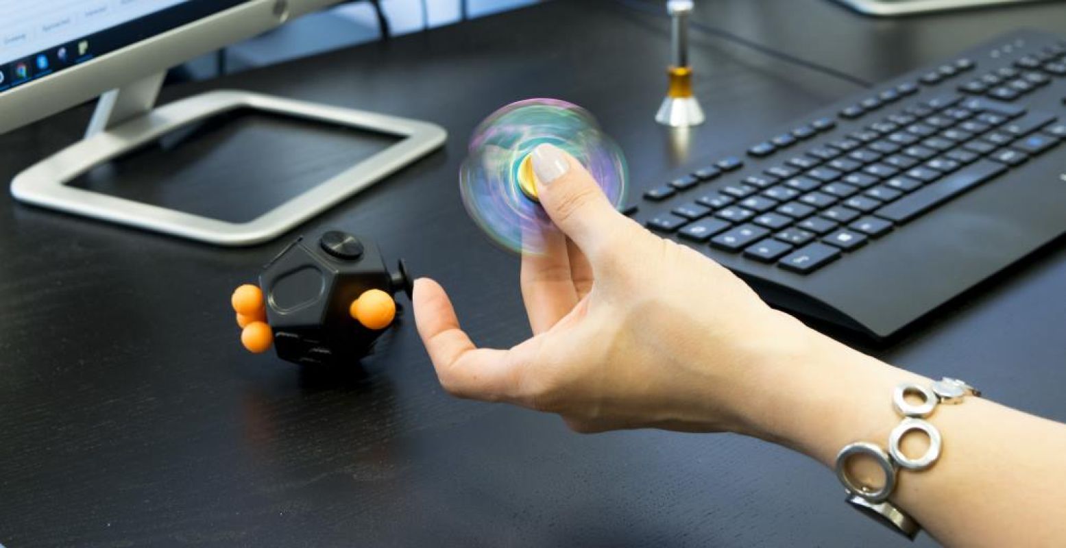 Helemaal hot: fidget spinners. 'Woman fidgeting while working in office'. Foto:  fidgetcircle . Licentie:  Sommige rechten voorbehouden . Bron:  Flickr.com 