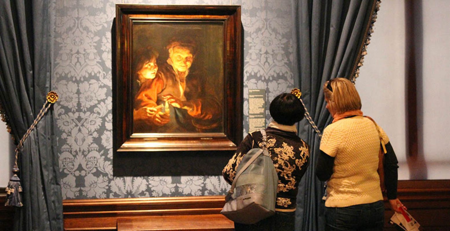 Twee vrouwen bekijken 'Oude vrouw en jongen met kaarsen' van Peter Paul Rubens uit circa 1616-1617. Foto: DagjeWeg.NL.