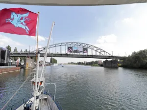 De Blauwe Bever vaart onder de John Frostbrug door met de pegasus vlag in top. fotograaf: Cees van D De Blauwe Bever vaart onder de John Frostbrug door met de pegasus vlag in top. fotograaf: Cees van D